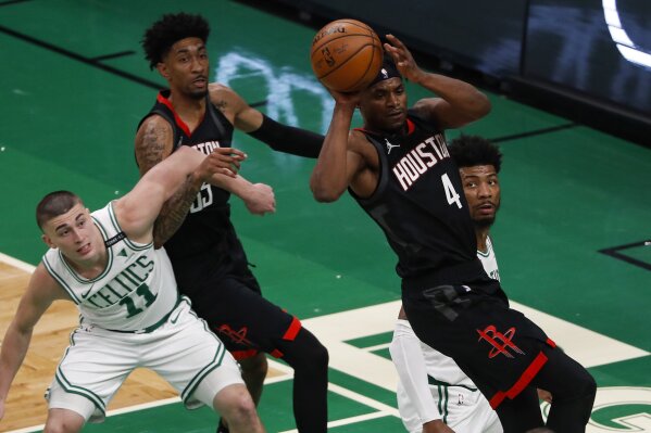 Houston Rockets' Danuel House Jr. passes the ball away from Boston Celtics' Marcus Smart and Payton Pritchard (11) during the second quarter of an NBA basketball game Friday, April 2, 2021, in Boston. (AP Photo/Winslow Townson)