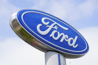 FILE - A Ford sign is seen at a dealership in Springfield, Pa., April 26, 2022. The National Transportation Safety Board is investigating a March 3, 2024, crash near Philadelphia that killed two people and involved a Ford electric vehicle that may have been operating on a partially automated driving system. (AP Photo/Matt Rourke, File)