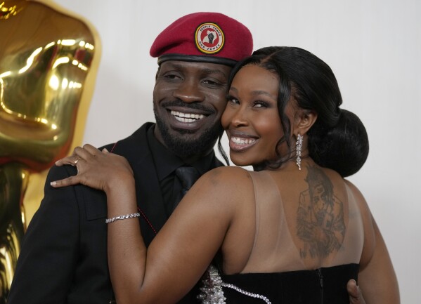 Bobi Wine, left, and Barbie Kyagulanyi arrive at the Oscars on Sunday, March 10, 2024, at the Dolby Theatre in Los Angeles. (AP Photo/Ashley Landis)