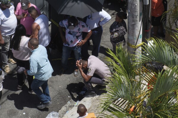 A police officer reacts during the search for survivors at the Jet Set nightclub after its roof collapsed during a concert in Santo Domingo, Dominican Republic, Tuesday, April 8, 2025. (AP Photo/Ricardo Hernandez)