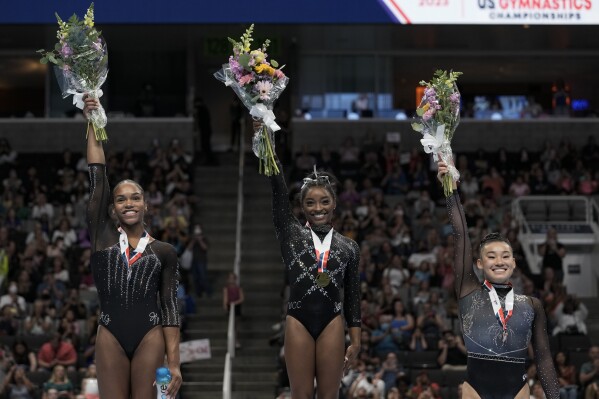 Frome left, Shilese Jones, Simone Biles and Leanne Wong pose for a photograph after placing second, first and third place, respectively, in all-around competition at the U.S. Gymnastics Championships, Sunday, Aug. 27, 2023, in San Jose, Calif. (AP Photo/Godofredo A. Vásquez)