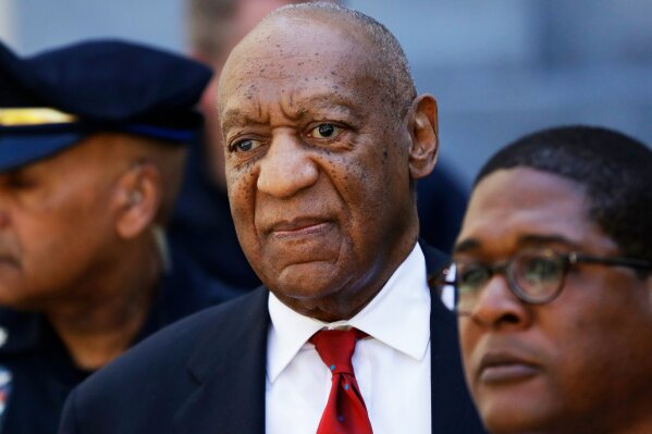 
              FILe - In this April 26, 2018 file photo, Bill Cosby, center, leaves the the Montgomery County Courthouse in Norristown, Pa. A representative from the Sexual Offenders Assessment Board has issued an assessment recommending that Bill Cosby be classified as a sexually violent predator. Cosby, 81, was convicted April 26 on sexual assault charges related to accusations he had drugged and assaulted Andrea Constand in his home in 2004. He is scheduled for sentencing on Sept. 24. (AP Photo/Matt Slocum, File)
            