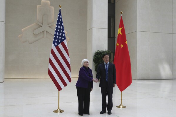 U.S. Treasury Secretary Janet Yellen, left, shakes hands with Governor of the People's Bank of China Pan Gongsheng as they meet at the People's Bank of China in Beijing Monday, April 8, 2024. (AP Photo/Tatan Syuflana, Pool)