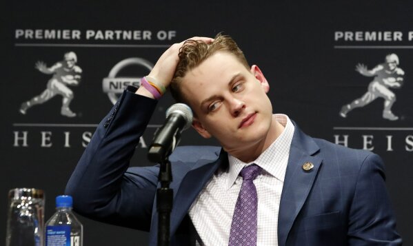 NCAA college football player and Heisman Trophy finalist, LSU quarterback Joe Burrow listens to questions from the media during a news conference before the Heisman Trophy ceremony, Saturday, Dec. 14, 2019, in New York. (AP Photo/Jason Szenes)