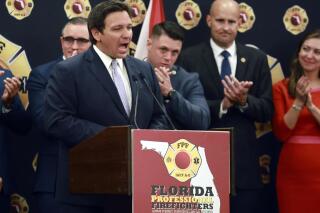 Florida Gov. Ron DeSantis speaks to the applause of firefighters as he accepts the endorsement of the Florida Professional Firefighters during a gathering at the Hilton Orlando in Orlando, Fla., on Tuesday, July 12, 2022. DeSantis received the endorsement despite the fact that he dissolved the Disney Community Development District, which funded the Reedy Creek Fire District, earlier in the year. (Stephen M. Dowell/Orlando Sentinel via AP)