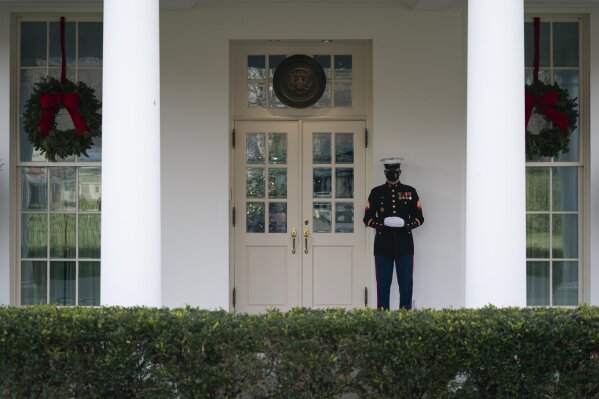 A Marine stands outside the entrance to the West Wing of the White House, signifying the President is in the Oval Office, Monday, Dec. 21, 2020, in Washington. (AP Photo/Evan Vucci)