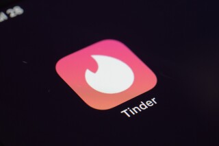 FILE - The icon for the dating app Tinder appears on a device, July 28, 2020, in New York. Tinder, Hinge and other dating apps are designed with addictive features that encourage “compulsive” use, a proposed class action lawsuit against parent company Match Group claims. The lawsuit filed Wednesday, Feb. 14, 2024, says Match intentionally designs its dating platforms with game-like features that “lock users into a perpetual pay-to-play loop” prioritizing profit over promises to help users find relationships. (AP Photo/Patrick Sison, File)