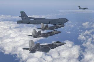 FILE - In this photo provided by South Korean Defense Ministry, a U.S. B-52 bomber, C-17, and U.S. Air Force F-22 fighter jets fly over the Korean Peninsula during a joint air drill in South Korea on Dec. 20, 2022. The United States flew nuclear-capable B-52 bombers to the Korean Peninsula again on Wednesday, April 5, 2023, in a show of strength against North Korea amid concerns that the North might conduct a nuclear test. (South Korean Defense Ministry via AP, File)