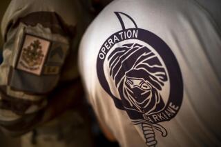 FILE - French Barkhane force soldiers who wrapped up a four-month tour of duty in the Sahel leave their base in Gao, Mali, June 9, 2021. France said Sunday, Jan. 23, 2022 that one of its soldiers has been killed in an attack on a base in Mali.A French Army statement said the 24-year-old artilleryman, Alexandre Martin, was serving with France’s anti-insurgent force Operation Barkhane. (AP Photo/Jerome Delay, file)