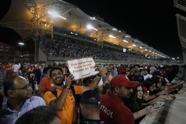 An F1 fan holds a placard during the Formula One Bahrain Grand Prix presentation ceremony at the Bahrain International Circuit in Sakhir, Bahrain, Sunday, April 13, 2025. (AP Photo/Altaf Qadri)