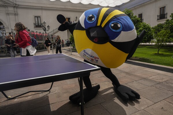 FILE - The Pan American Games mascot Fiu, a bird, poses for pictures at a countdown ceremony for the start of the 2023 Pan American Games and Parapam Games at La Moneda presidential palace in Santiago, Chile, Oct. 20, 2022. The Games are Oct. 20 - Nov. (AP Photo/Esteban Felix)