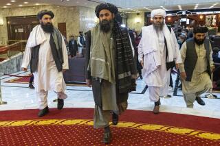 FILE  - In this file photo taken on Thursday, March 18, 2021, Taliban co-founder Mullah Abdul Ghani Baradar, center, arrives with other members of the Taliban delegation for an international peace conference in Moscow, Russia. A delegation of the Taliban visited Moscow on Thursday, July 8, 2021 to offer assurances that their quick gains in Afghanistan don't threaten Russia or its allies in Central Asia. (AP Photo/Alexander Zemlianichenko, Pool, File)