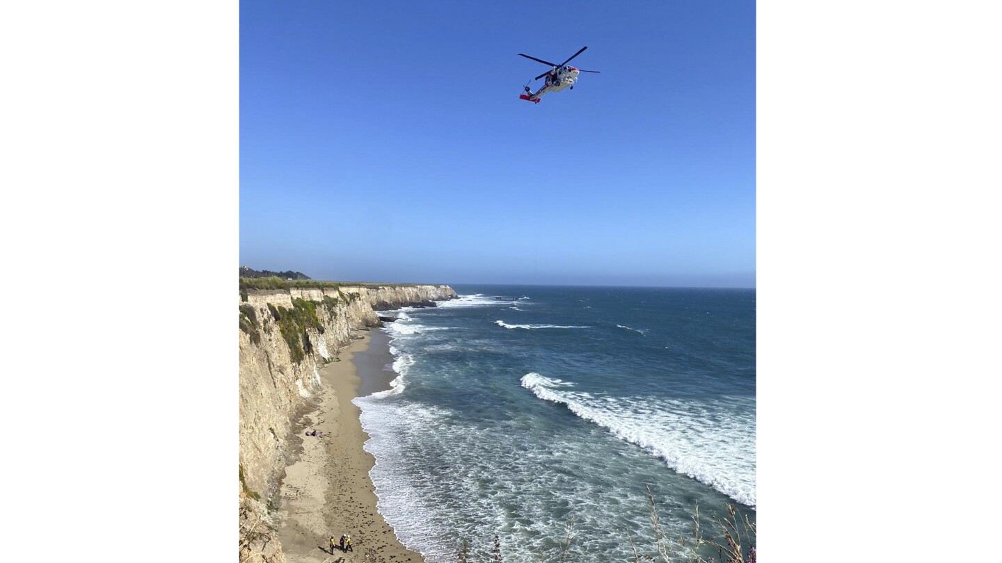 Kite surfer rescued from remote California beach rescued after making 'HELP' sign with rocks