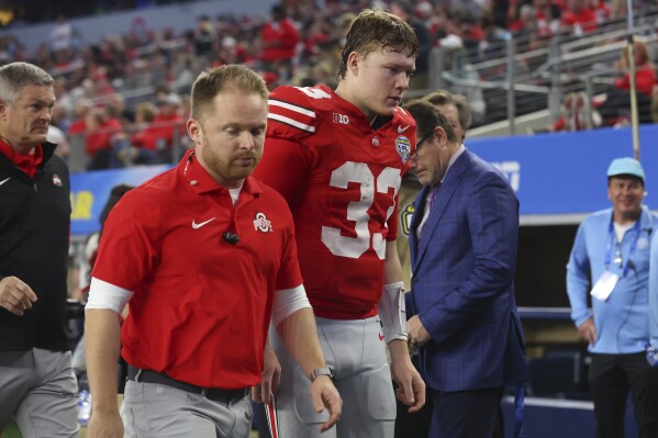 Ohio State quarterback Devin Brown (33) walks off the field during the first half of the team's Cotton Bowl NCAA college football game against Missouri on Friday, Dec. 29, 2023, in Arlington, Texas. (AP Photo/Richard W. Rodriguez)