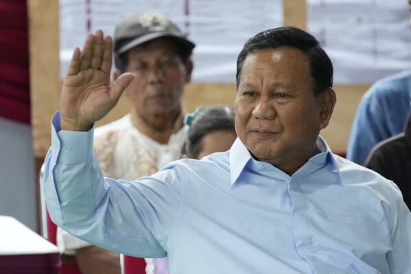 Indonesian presidential candidate Prabowo Subianto checks his ballot during the election in Bojong Koneng, Indonesia, Wednesday, Feb. 14, 2024. Defense Minister Subianto, a wealthy ex-general with ties to both Indonesia’s popular outgoing president and its dictatorial past looks set to be its next president, after unofficial tallies showed him taking a clear majority in the first round of voting.(AP Photo/Vincent Thian)