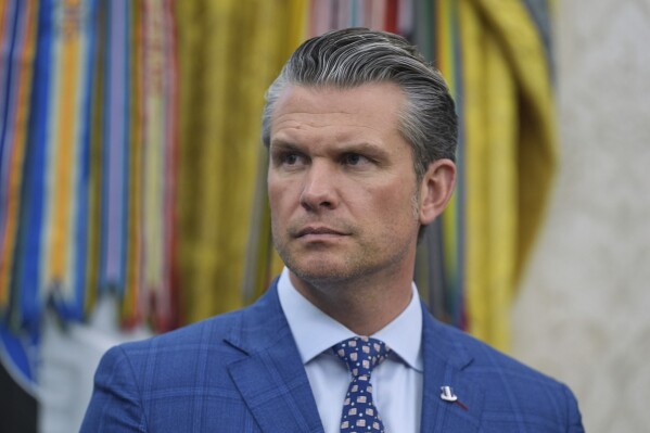 Defense Secretary Pete Hegseth listens during an event with President Donald Trump to sign executive orders regarding nuclear energy in the Oval Office of the White House, Friday, May 23, 2025, in Washington. (AP Photo/Evan Vucci)