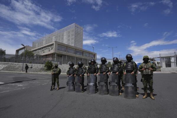 Soldiers stand guard outside the National Assembly the day after the body was disolved by President Guillermo Lasso in Quito, Ecuador, Thursday, May 18, 2023. Lawmakers were moving forward with impeachment proceedings against the president on embezzlement charges when he disolved it, and now residents are expected to elect a new president and a new lawmakers in no more than 90 days. (AP Photo/Dolores Ochoa)