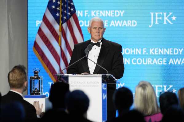 Former Vice President Mike Pence acknowledges a standing ovation as he speaks after receiving the John F. Kennedy Profile in Courage Award during a ceremony at the JFK Library, Sunday, May 4, 2025, in Boston. (AP Photo/Robert F. Bukaty)