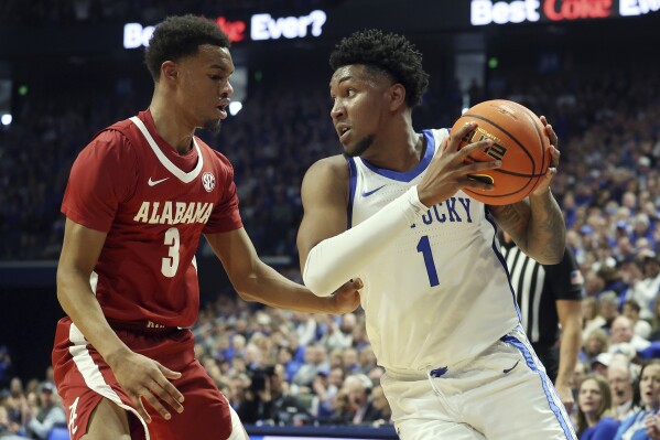 Kentucky's Justin Edwards (1) looks for an opening against Alabama's Rylan Griffen (3) during the first half of an NCAA college basketball game Saturday, Feb. 24, 2024, in Lexington, Ky. (AP Photo/James Crisp)