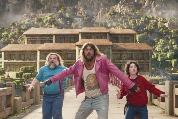 This image released by Warner Bros. Pictures shows, from left, Jack Black, Jason Momoa and Sebastian Hansen in a scene from "A Minecraft Movie." (Warner Bros. Pictures via AP)