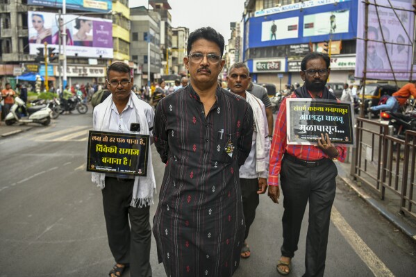 Avinash Patil, center, an activist and leader of the Maharashtra Andhashraddha Nirmulan Samiti, an anti-superstition group, marches on the 10th death anniversary of its founder and renowned rationalist, Narendra Dabholkar, who was gunned down during a morning walk in Pune, India, Sunday, Aug 20, 2023. The nones in India come from an array of belief backgrounds, including Hindu, Muslim and Sikh. The surge of Hindu nationalism has shrunk the space for the nones over the last decade, activists say. (AP Photo)