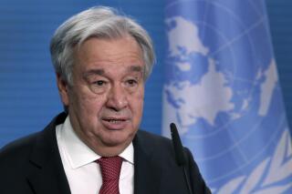 FILE - In this Dec. 17, 2020 file photo, UN Secretary-General Antonio Guterres addresses the media during a joint press conference in Berlin, Germany. The head of the United Nations is calling for “immediate, rapid and large-scale” cuts in greenhouse gas emissions to curb global warming. Antonio Guterres warned governments ahead of next week's annual U.N. General Assembly that climate change is proceeding faster than predicted and fossil fuel emissions have already bounced back from a pandemic dip. Speaking at the launch of a U.N.-backed report summarizing current efforts to tackle climate change, Guterres said recent extreme weather showed no country is safe from climate-related disasters. (AP Photo/Michael Sohn, pool, File)