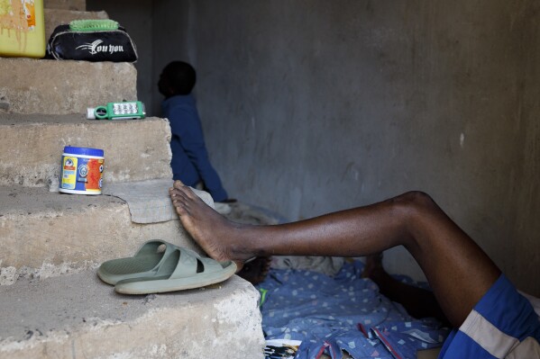 Kush users rest in a room where they receive care in an unconventional rehabilitation centre in the Bombay community, in Freetown, Sierra Leone, Thursday, April 25, 2024. Some youth in the Bombay community are helping Kush addicts stop by rehabilitating them. (AP Photo/ Misper Apawu)