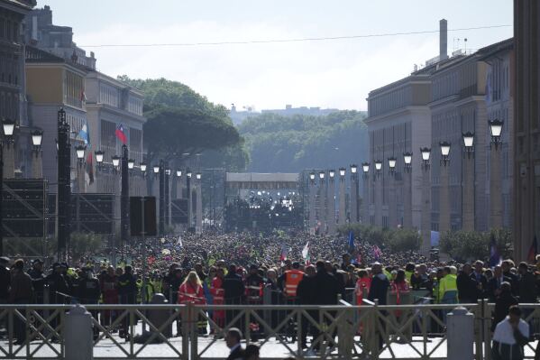 People queue trying to reach St. Peter's Square ahead of the funeral of Pope Francis at the Vatican, Saturday, April 26, 2025. (AP Photo/Andrew Medichini)