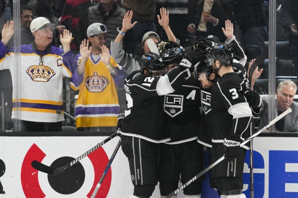 Los Angeles Kings right wing Viktor Arvidsson (33) celebrates with teammates after scoring during the second period of an NHL hockey game against the Chicago Blackhawks Thursday, April 18, 2024, in Los Angeles. (AP Photo/Ashley Landis)