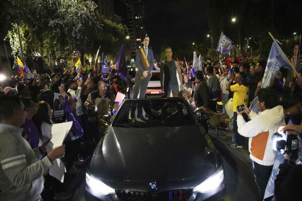 Supporters of President Daniel Noboa celebrate early returns showing him in the lead in the presidential election runoff in Quito, Ecuador, Sunday, April 13, 2025. (AP Photo/Carlos Noriega)