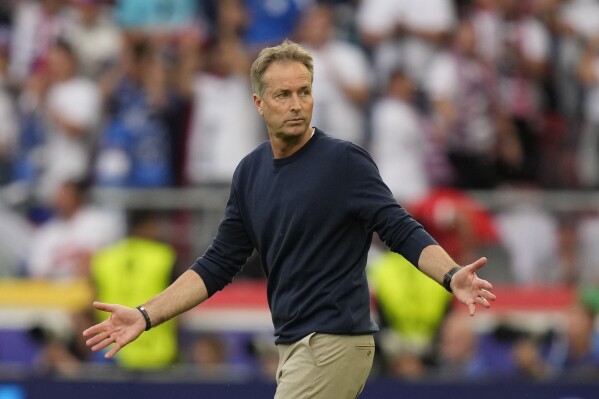 Denmark's head coach Kasper Hjulmand reacts as he walks onto the pitch after the of the Group C match between Slovenia and Denmark at the Euro 2024 soccer tournament in Stuttgart, Germany, Sunday, June 16, 2024. The game ended 1-1. (AP Photo/Matthias Schrader)