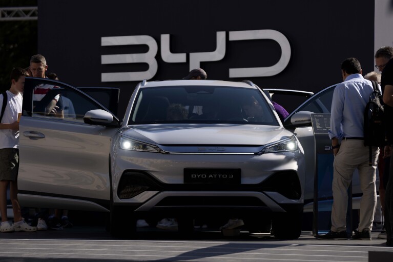 File - Visitors watch the BYD ATTO 3 at the IAA motor show in Munich, Germany, Friday, Sept. 8, 2023. The international motor show IAA Mobility 2023 takes place in Munich from Sept. 5 until Sept. 10, 2023. Chinese automakers are winning over drivers as they make major inroads into Europe’s electric vehicle market, challenging long-established homegrown brands in an industry that’s key to the continent’s green energy transition. The European Union has launched an investigation into Beijing’s support for its EV industry, adding to tensions between the West and China. (AP Photo/Matthias Schrader, File)