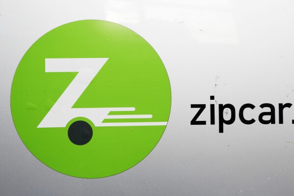 FILE - A Zipcar logo is shown, Jan. 2, 2013 in New York. Zipcar has been slapped with a $300,000 fine after U.S. regulators found that the car-sharing company allowed customers to rent vehicles with open recalls, violating federal motor safety law. The civil penalty is a part of a consent order announced by the National Highway Traffic and Safety Administration — marking the first enforcement action against a rental car company over recalls. (AP Photo/Mark Lennihan, file)