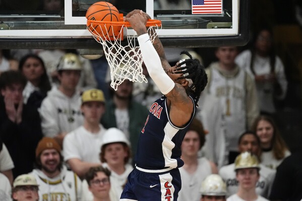 Arizona guard Caleb Love dunks against Colorado during the second half of an NCAA college basketball game Saturday, Feb. 10, 2024, in Boulder, Colo. (AP Photo/David Zalubowski)