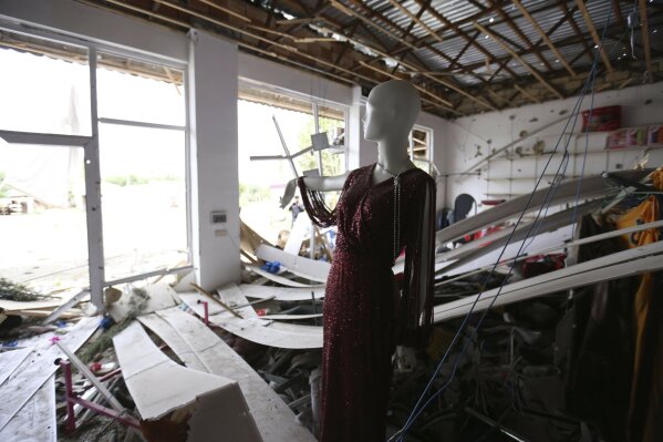 A mannequin inside a shop damaged by shelling during fighting over the breakaway region of Nagorno-Karabakh in Agdam, Azerbaijan, Thursday, Oct. 1, 2020. Clashes broke out Sunday in Nagorno-Karabakh, a region within Azerbaijan that has been controlled by ethnic Armenian forces backed by the Armenian government since the end of a separatist war a quarter-century ago. (AP Photo/Aziz Karimov)