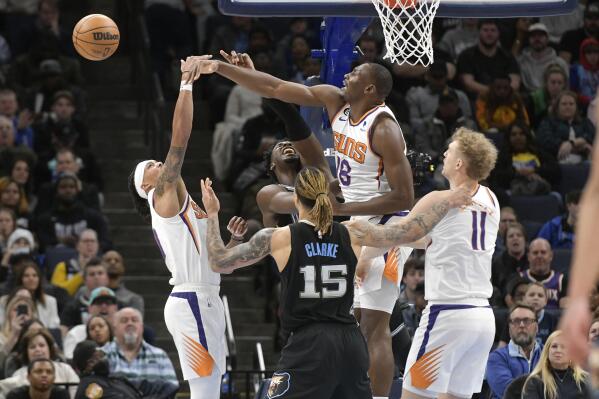 Phoenix Suns center Bismack Biyombo defends against Memphis Grizzlies forward Jaren Jackson Jr. in the first half of an NBA basketball game, Tuesday, Dec. 27, 2022, in Memphis, Tenn. (AP Photo/Brandon Dill)