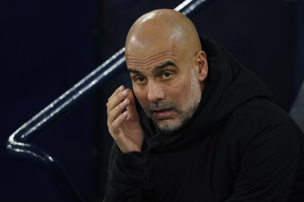 Manchester City's head coach Pep Guardiola grimaces before the group G Champions League soccer match between Manchester City and Young Boys at the Etihad Stadium in Manchester, England, Tuesday, Nov. 7, 2023. (AP Photo/Dave Thompson)