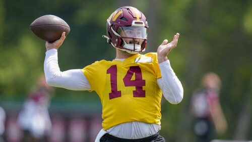 FILE - Washington Commanders quarterback Sam Howell (14) throws during an NFL football practice at the team's training facility, Wednesday, May 24, 2023 in Ashburn, Va. The Washington Commanders go into a fourth training camp under coach Ron Rivera with second-year pro Sam Howell opening as the starting quarterback. (AP Photo/Alex Brandon, File)