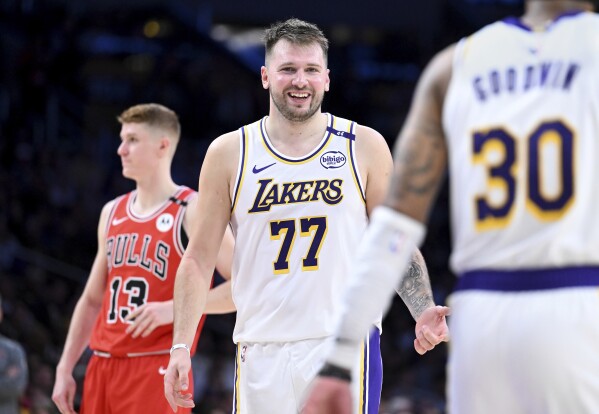 Los Angeles Lakers guard Luka Doncic (77) smiles after making a basket against the Chicago Bulls of an NBA basketball game Saturday, March 22, 2025, in Los Angeles. (AP Photo/Wally Skalij)