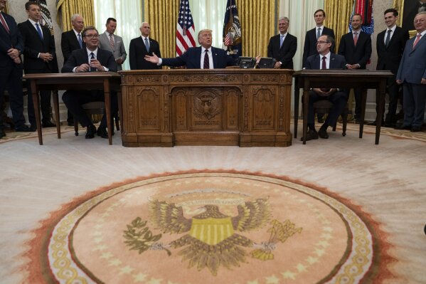 President Donald Trump participates in a signing ceremony with Serbian President Aleksandar Vucic, left, and Kosovar Prime Minister Avdullah Hoti, in the Oval Office of the White House, Friday, Sep...