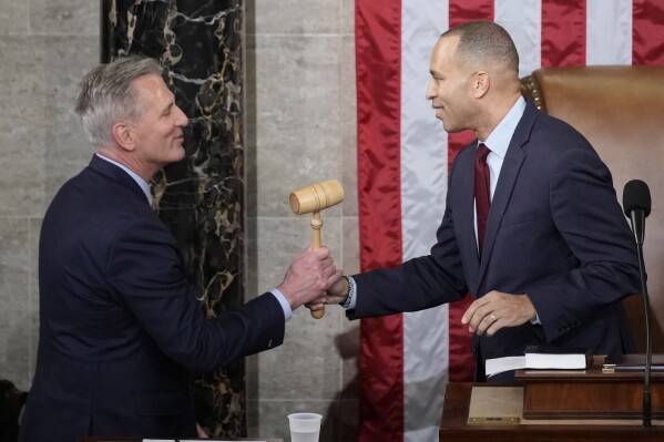 FILE - Incoming House Speaker Kevin McCarthy of Calif., receives the gavel from House Minority Leader Hakeem Jeffries of N.Y., on the House floor at the U.S. Capitol in Washington, early Saturday, Jan. 7, 2023. Republican McCarthy was elected House speaker on a historic post-midnight 15th ballot. (Ǻ Photo/Andrew Harnik, File)