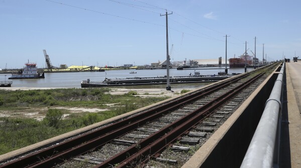 A barge is grounded next to the Pelican Island Bridge in Galveston, Texas on Wednesday, May 15, 2024, after it collided with the old rail bridge that runs alongside it. The collision shut down the only road access to and from Pelican Island. (Jennifer Reynolds/The Galveston County Daily News via AP)