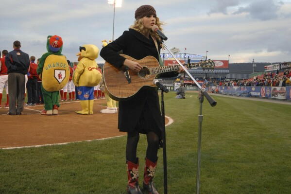 This photo provided by the Reading Fightin Phils shows Taylor Swift singing the national anthem before a Reading Fightin Phils minor league baseball game at First Energy Stadium in Reading, Pa., April 5, 2007. Taylor Swift got her singing career started by performing the national anthem at sporting events as a young child and teenager. (Reading Fightin Phils via AP)