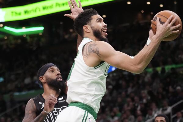 Boston Celtics forward Jayson Tatum, right, drives to the basket against Brooklyn Nets forward Royce O'Neale during the first half of an NBA basketball game, Wednesday, Feb. 1, 2023, in Boston. (AP Photo/Charles Krupa)