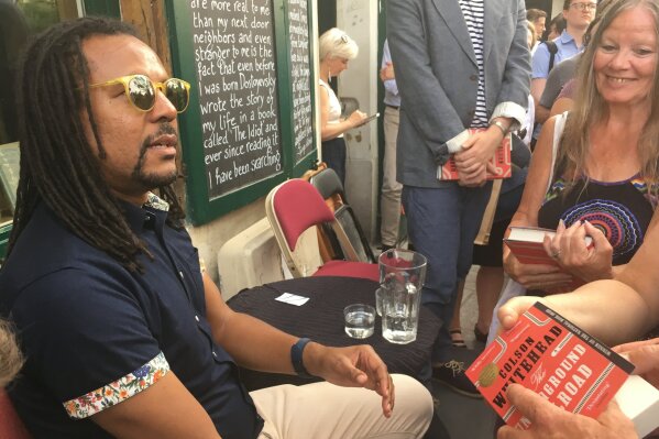 FILE - In this June 20, 2017, file photo, novelist Colson Whitehead speaks to fans after discussing his Pulitzer prize-winning book "The Underground Railroad" at the English-language bookstore Shakespeare and Company in Paris. Already this year's recipient of the Pulitzer Prize for fiction and the Orwell Prize for political fiction, Whitehead is now being honored by the Library Congress. On Monday, July 13, the library announced that he had won the Library of Congress Prize for American Fiction. (AP Photo/Russell Contreras, File)