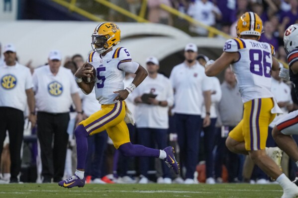 LSU quarterback Jayden Daniels (5) carries on a keeper in the first half of an NCAA college football game against Auburn in Baton Rouge, La., Saturday, Oct. 14, 2023. (AP Photo/Gerald Herbert)