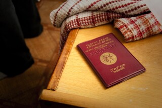 FILE - A passport of an Ethiopian fighter pilot on display at a residence, in Tok Mok, Kyrgyzstan, on Monday Aug. 16, 2010. The European Union is tightening visa requirements for people from Ethiopia, it was reported on Monday, April 29, 2024. It says the government there is not cooperating on the deportation of citizens found to be living illegally in the bloc. (AP Photo/Dalton Bennett, File)