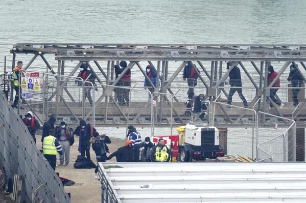 A group of people thought to be migrants are brought in to Dover, Kent, onboard a Border Force vessel following a small boat incident in the Channel, England, Monday March 6, 2023. The British government said Monday it will introduce legislation to ban anyone who arrives in the U.K. in small boats across the English Channel from ever settling in the country. (Gareth Fuller/PA via AP)