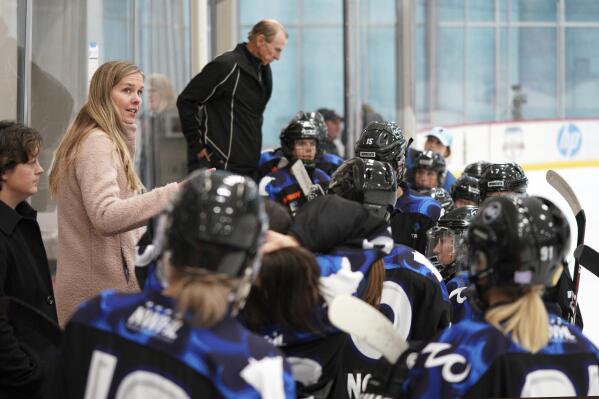Minnesota Whitecaps coach Ronda Engelhardt talks with players on the bench during a hockey game against the Metropolitan Riveters in St. Paul, Minn., Saturday, Oct. 12, 2019. The Nashville Predators have hired their first female scout with Ronda Engelhardt as a North American amateur scout based out of Minnesota. The Predators announced a handful of changes on their hockey operations staff Wednesday, Sept. 14, 2022.  (Anthony Souffle/Star Tribune via AP)