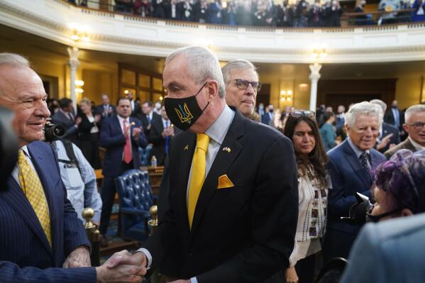 New Jersey Gov. Phil Murphy, wearing a mask with the Ukraine coat of arms, arrives for his budget address in Trenton, N.J., Tuesday, March 8, 2022. New Jersey Democratic Gov. Phil Murphy has proposed a $48.9 billion budget that boosts K-12 funding, makes a full public pension payment for the second straight year, redistributes nearly $1 billion in property tax relief and raises overall spending by about 5% over last year's plan. Murphy unveiled the proposal during a speech Tuesday in the Assembly chamber, the first time since 2020 and the COVID-19 outbreak. (AP Photo/Seth Wenig)